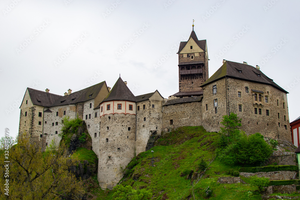 Facade of Loket Castle, a 12th-century gothic castle on Karlovarsky kraj, a rock on a hill, in Czech Republic