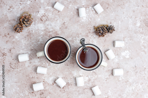 Two cup of hot chocolate with marshmallow on light background