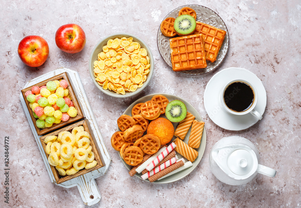 Breakfast with various sweets,wafers,corn flakes and a cup of coffee,top view Breakfast with various sweets,wafers,corn flakes and a cup of coffee,top view