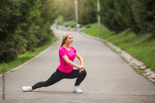 beautiful young woman in sports pink t-shirt goes in for sports