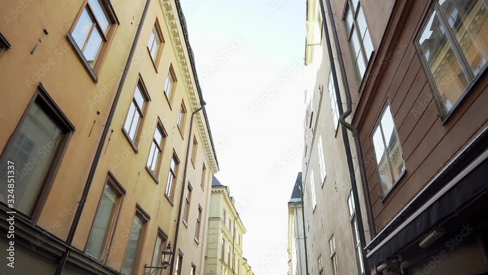 Apartment building streets in Stockholm area at winter. Scandinavian facades of old town houses in the narrow streets. Traveling concept. Slow motion. Steadicam shot Apartment building streets in Stockholm area at winter. Scandinavian facades of old town houses in the narrow streets. Traveling concept. Slow motion. Steadicam shot
