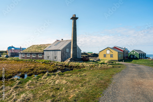 Colorful buildings and the charming city of Flatey Island in Iceland just outside Stykkisholmur and the Westfjords. The iconic pipe statue in the middle. Travel and visit concept © Jon Anders Wiken
