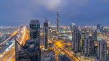 Beautiful panoramic skyline of Dubai day to night timelapse, United Arab Emirates. View of world famous skyscrapers.