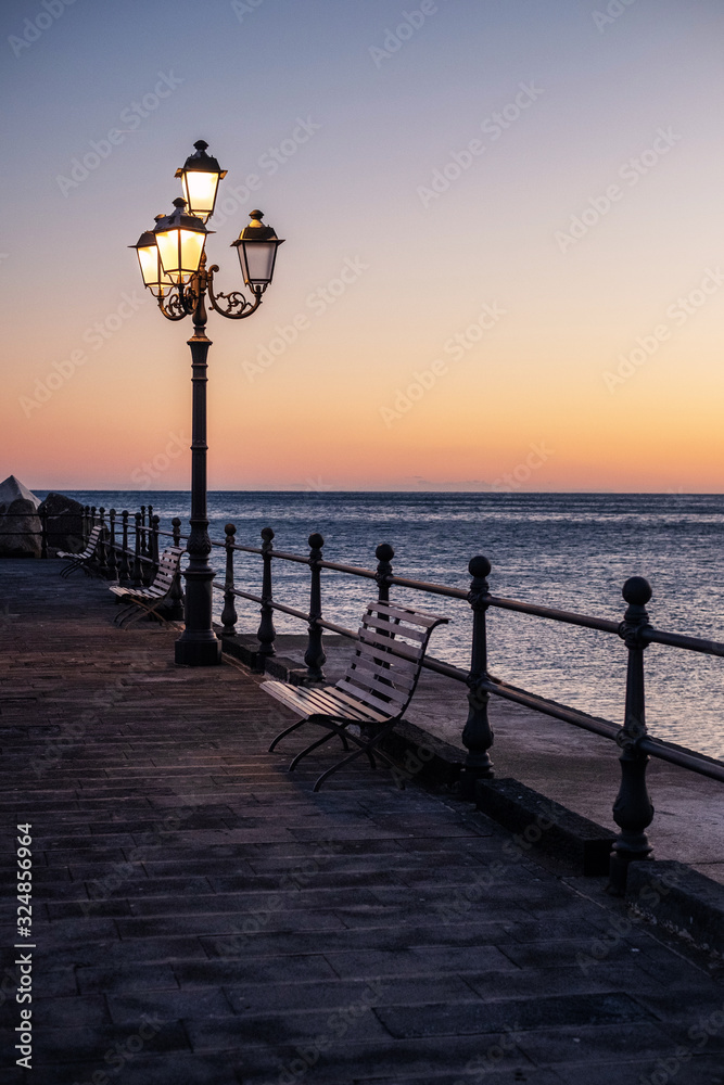 Pier in Amalfi town at sunset, Italy