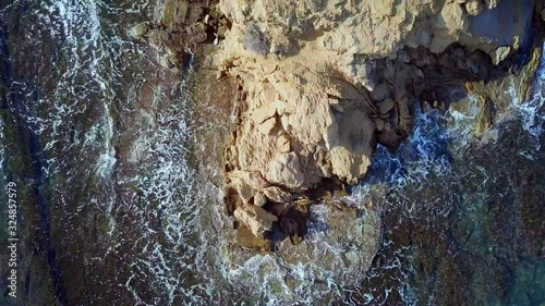 Waves are washing on stones and pebbles on the shore 4. Slow motion.