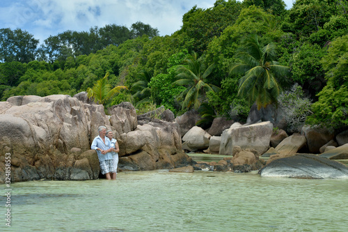 Happy elderly couple rest at tropical beach