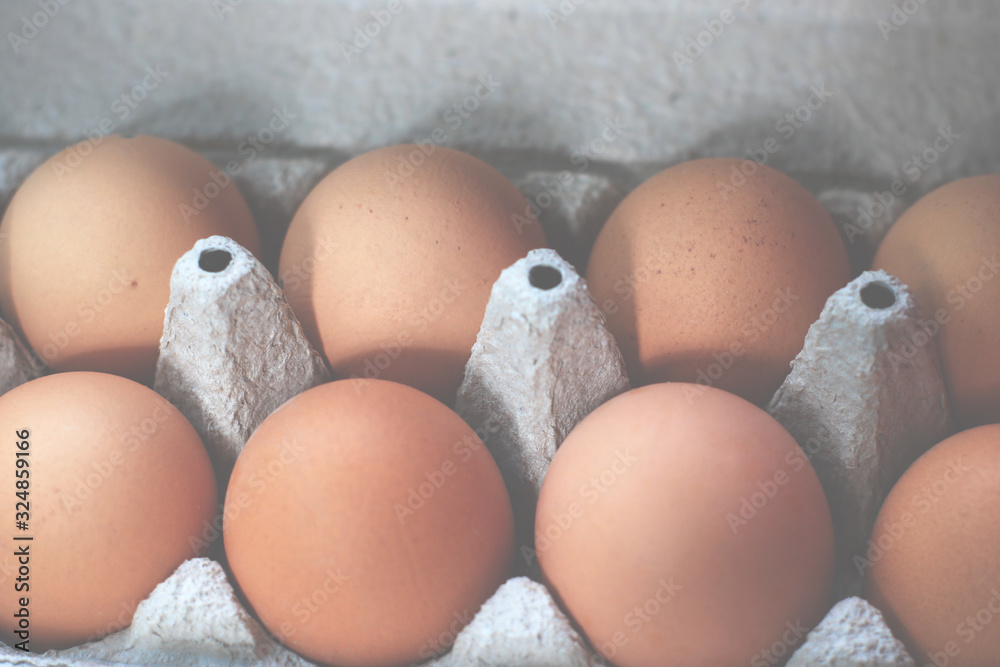 Large farm brown chicken eggs in an ecological cardboard box. Large farm brown chicken eggs in an ecological cardboard box.