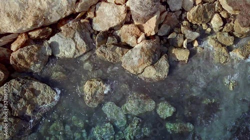 Waves are washing on stones and pebbles on the shore 4. Slow motion.