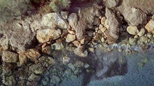 Waves are washing on stones and pebbles on the shore 4. Slow motion.