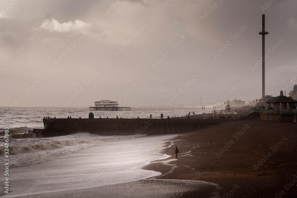 woman watching a storm at Brighton beach