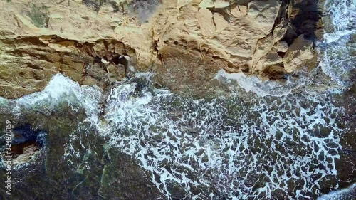 Waves are washing on stones and pebbles on the shore 4. Slow motion.