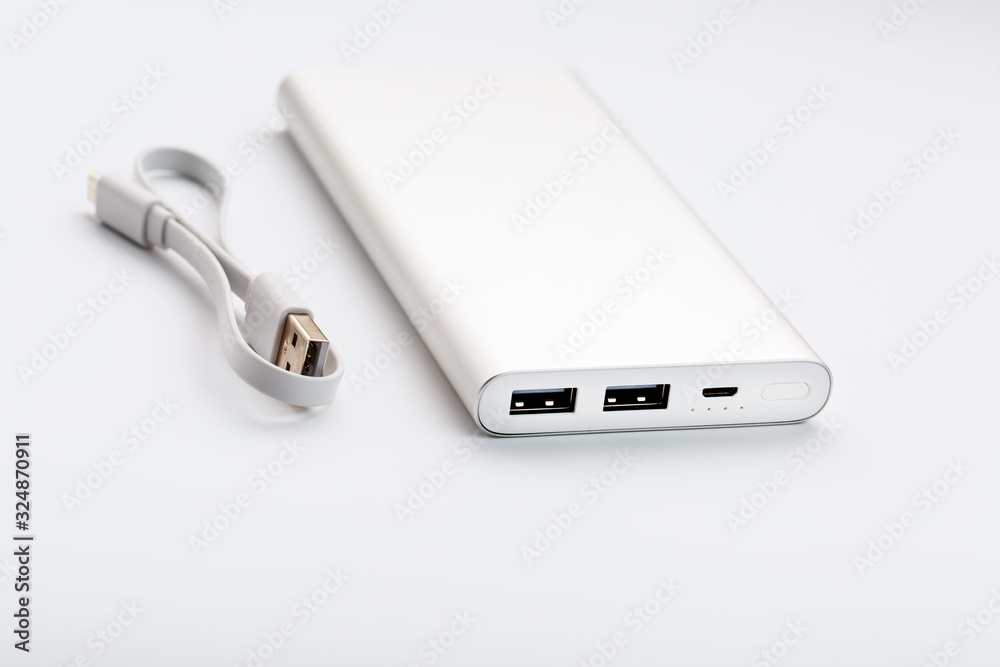 Power Bank for charging your smartphone on a white background. Universal external battery for gadgets free space and minimalistic composition. Power Bank for charging your smartphone on a white background. Universal external battery for gadgets free space and minimalistic composition.