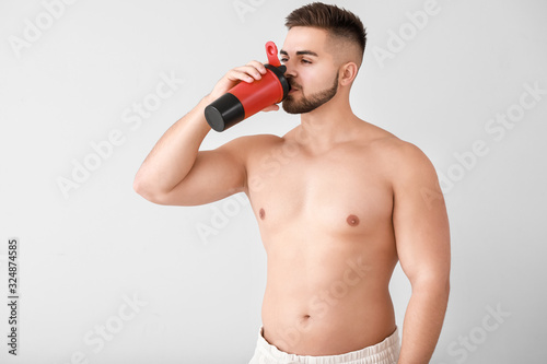 Sporty man with protein sha...