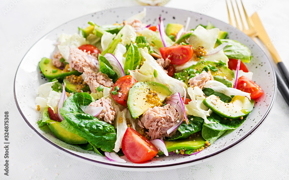 Tuna fish salad with lettuce, cherry tomatoes, avocado and red onions. Healthy food. French cuisine. Tuna fish salad with lettuce, cherry tomatoes, avocado and red onions. Healthy food. French cuisine.