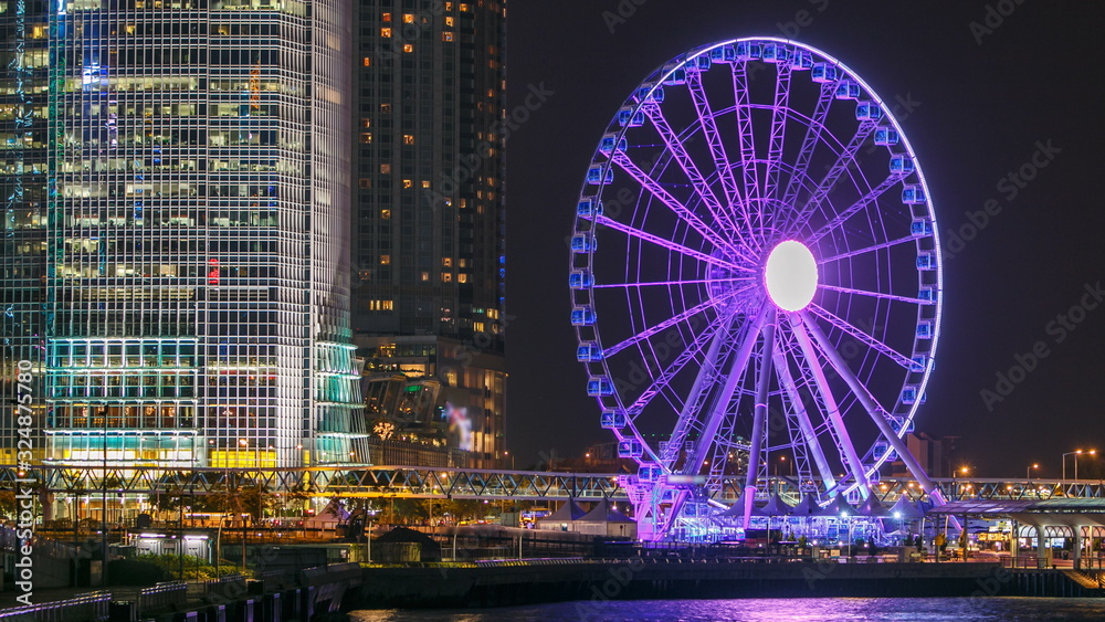 Skycrapers night timelapse and Hong Kong Observation Wheel, which is the latest tourist attraction in the city.