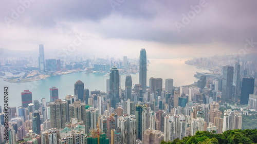 The famous view of Hong Kong from Victoria Peak night to day timelapse. Taken before sunrise with colorful clouds over Kowloon Bay.