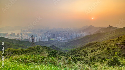 Cityscape of Hong Kong as viewed atop Kowloon Peak with sunset timelapse with Hong kong and Kowloon below photo