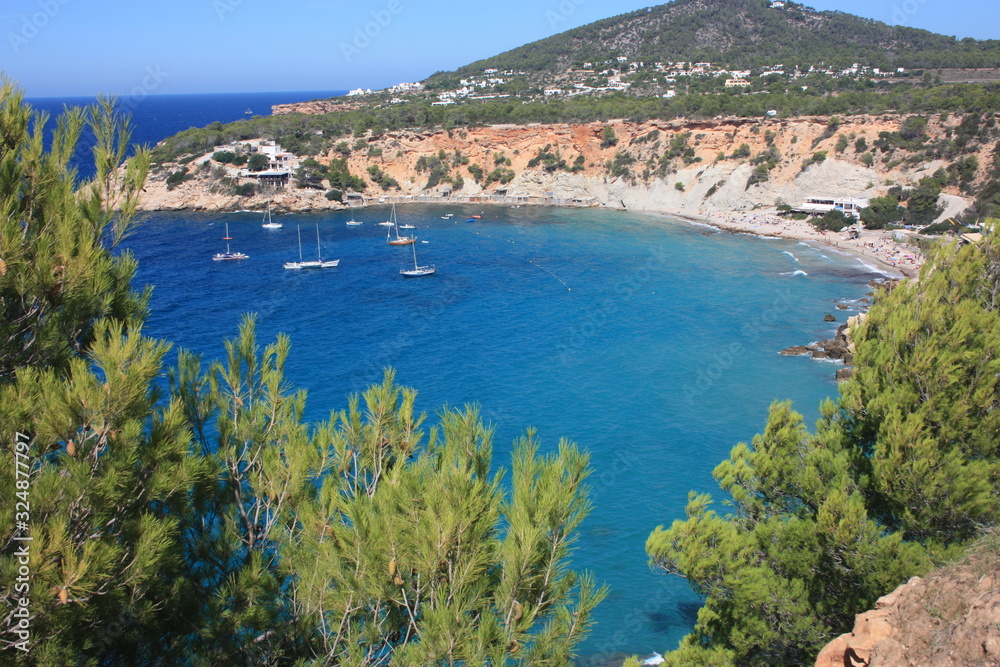 the blue sea of ibiza in summer and its bright colors between water and beaches in the coves the blue sea of ibiza in summer and its bright colors between water and beaches in the coves