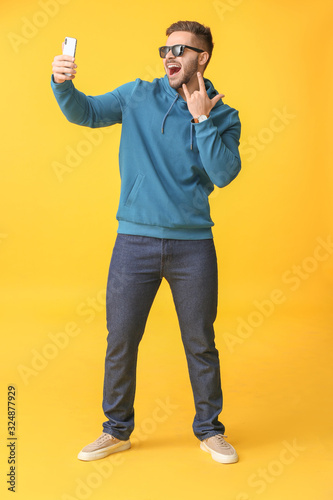 Cool young man taking selfi...