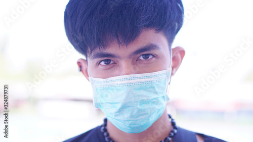 Sick Asian man wearing the surgical mask to protect the germ or virus from the air. 2019-Corona virus from China it's very dangerous. 