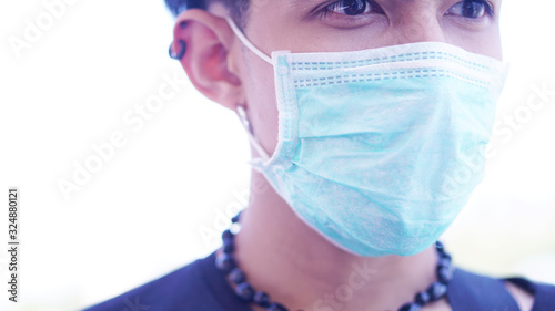 Sick Asian man wearing the surgical mask to protect the germ or virus from the air. 2019-Corona virus from China it's very dangerous. 