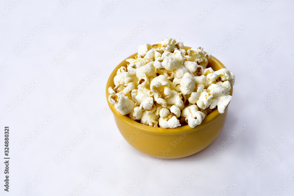 delicious popcorn inside yellow bowl on whith background with space for text delicious popcorn inside yellow bowl on whith background with space for text
