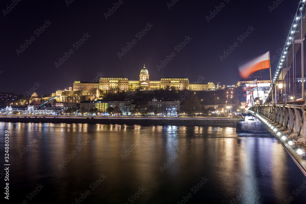 Buda Castle, Royal Palace by the Danube river illuminated at night in Budapest
