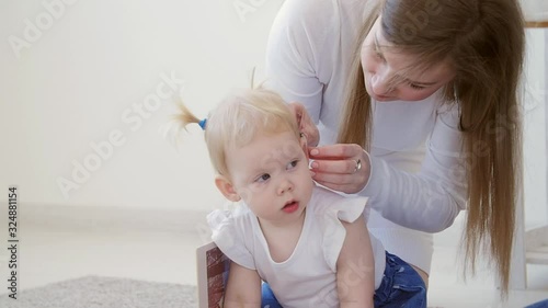 Concept of hearing impairment and their treatment. Cute little girl with a hearing aid