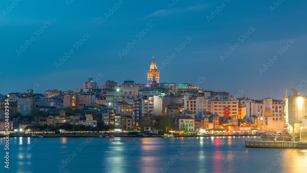 View over golden horn bay on the galata tower and its neighborhood day to night timelapse in Istanbul.