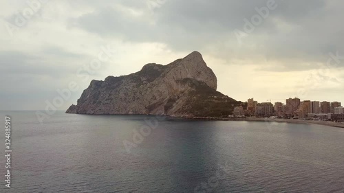 Aerial view big rock near Parque natural del Penon de Ifach in Calpe, symbol of Calpe town, 4k footage. Province of Alicante, Costa Blanca, Spain