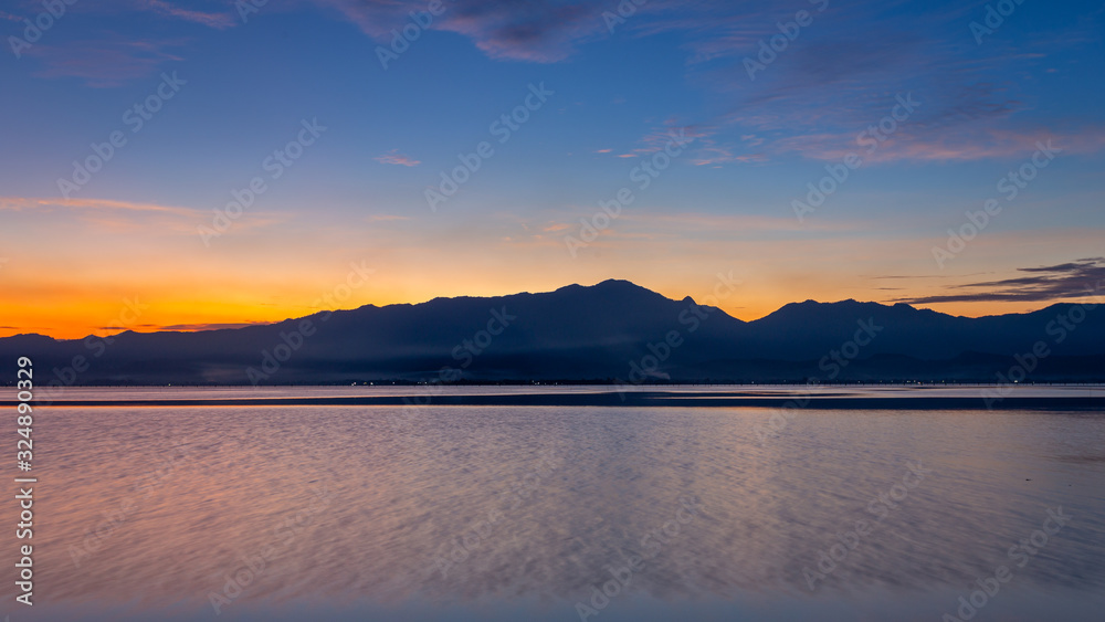 Panoramic Sunset and Blue sky over mountain and lake with the reflection