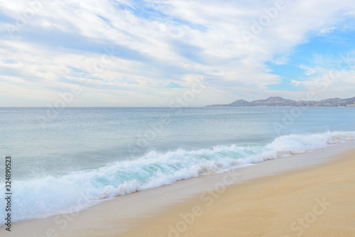 Set of pictures of a fantastic ocean wave in different stages. Cloudy sunrise sky. San Jose del Cabo. Mexico.