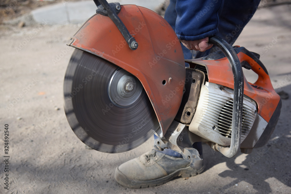 Fototapeta premium A worker takes a saw.