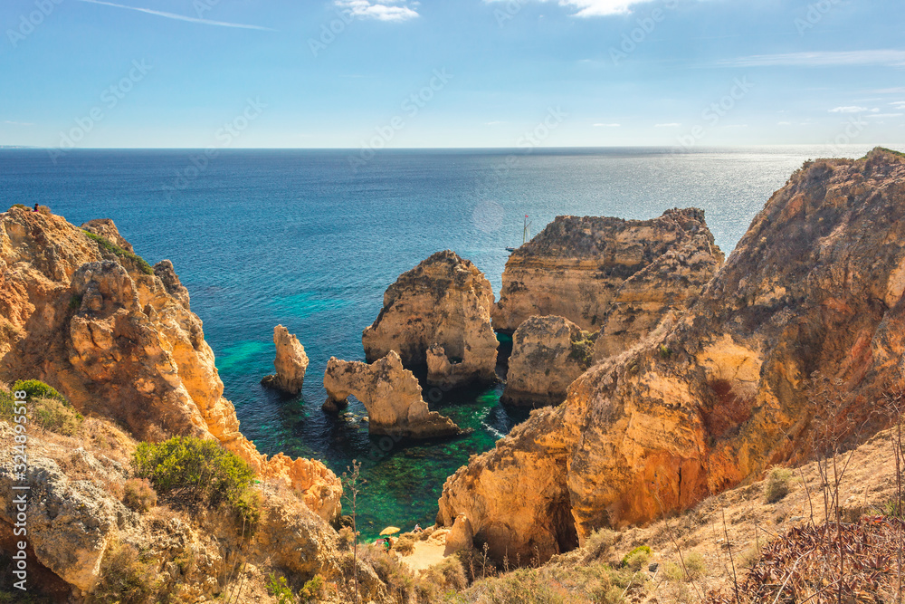 Fototapeta premium Turquoise sea bay among rocks and cliffs at Ponta da Piedade near Lagos, Algarve region, Portugal