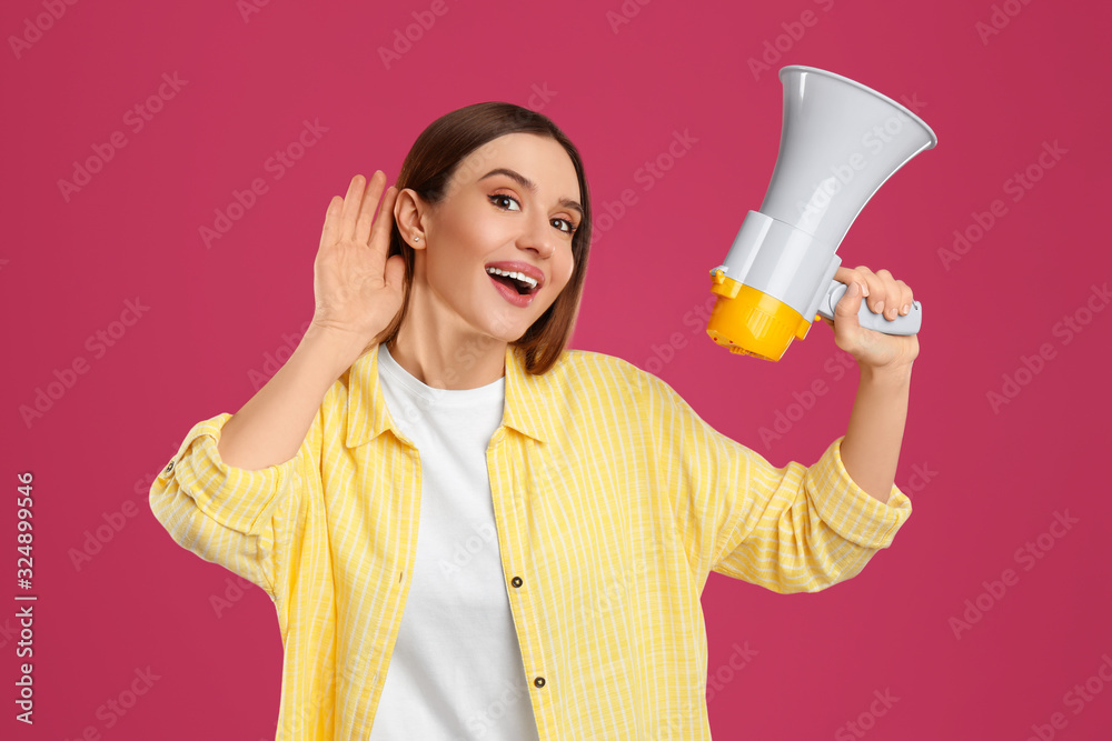 Young woman with megaphone on pink background Young woman with megaphone on pink background