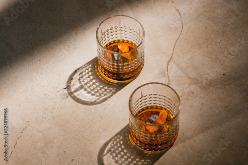 Old Fashioned Cocktail in Retro Glasses on Bar in Sunlight