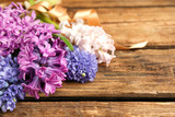 Beautiful spring hyacinth flowers on wooden table, closeup. Space for text