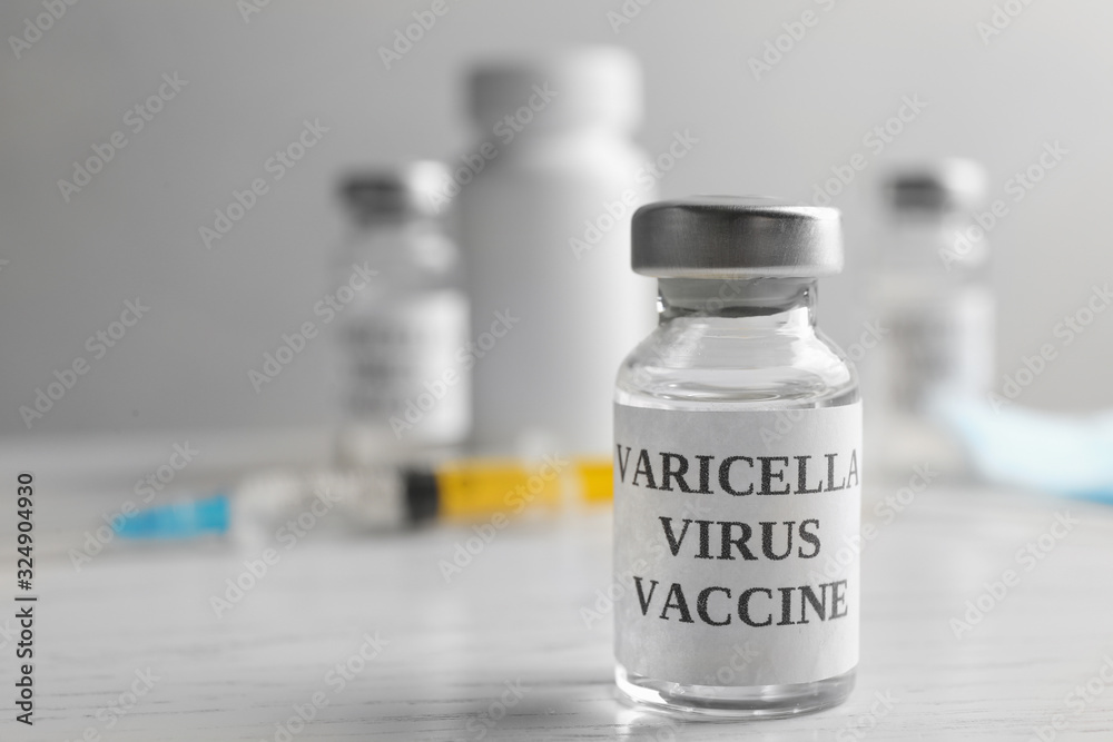Chickenpox vaccine on white wooden table, space for text. Varicella virus prevention Chickenpox vaccine on white wooden table, space for text. Varicella virus prevention