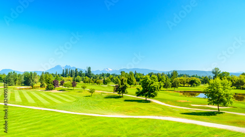 Wide and Top View at Golf course with gorgeous green and pond.