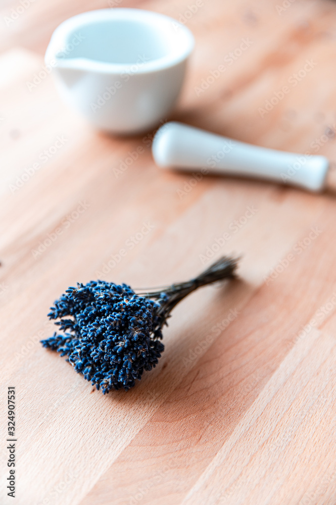 Top view of mortar and pestle with lavender flowers on wood table background. Natural cosmetic Top view of mortar and pestle with lavender flowers on wood table background. Natural cosmetic
