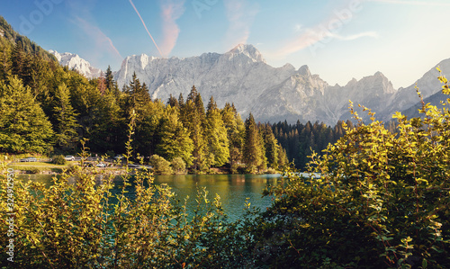 Wonderful Autumn landscape during sunset. Great view on fairy tale Fusine lake under sunlight. Picturesque view of nature. Amazing natural Background. Best popular places for travew. Beauty of World
