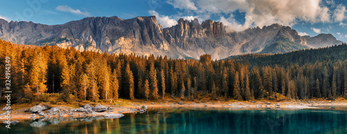 Awesome alpine highlands with dramatic sky. Scenic image of fairy-tale Landscape in Dolomites alps. incredible view majestic Dolomite alps with reflection on Lake Karersee, Lago di Carezza. panorama photo