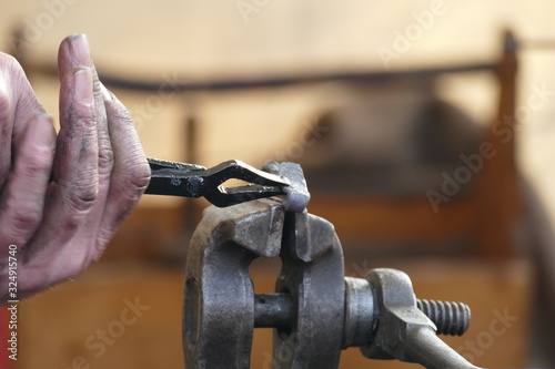 bending metal in a vice by a craftsman