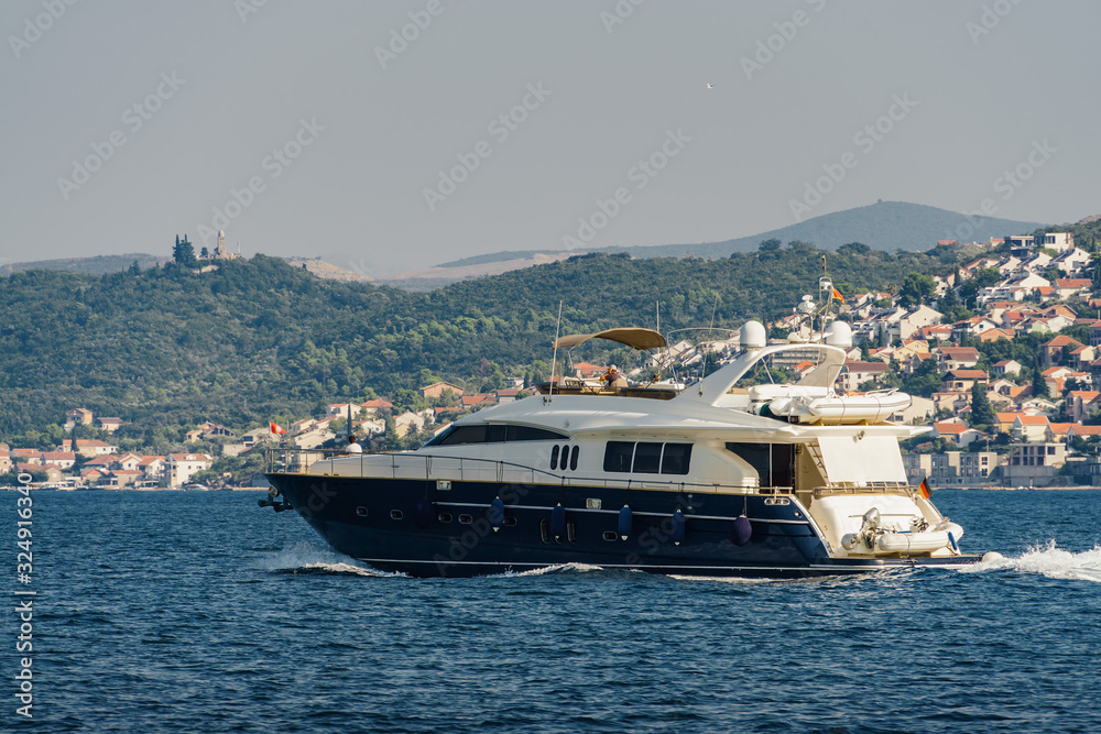 Sunny view of yacht in the Bay of Kotor near the town of Herceg Novi, Montenegro.