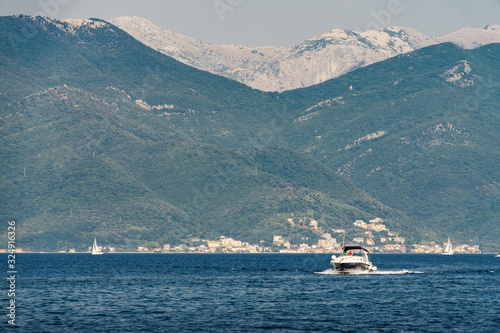 Sunny view of yacht in the Bay of Kotor near the town of Herceg Novi, Montenegro.