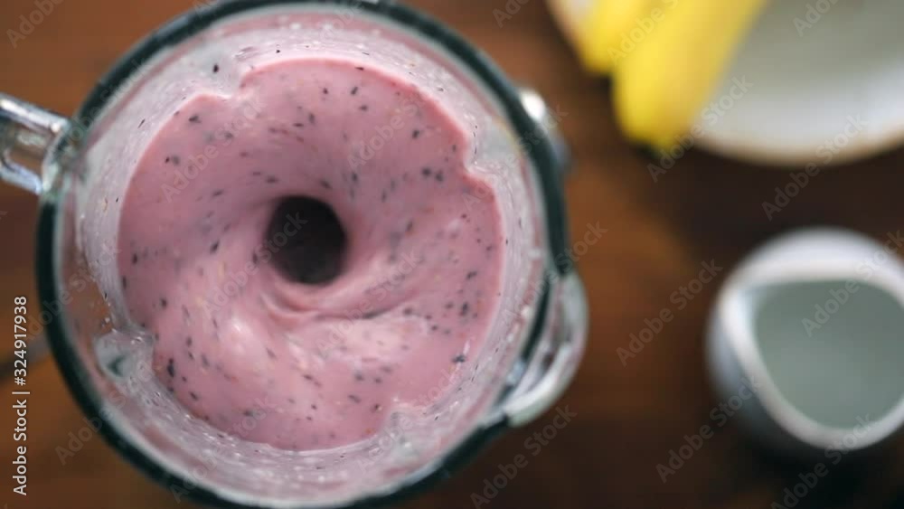 High angle view on a fast working blender with fruit smoothie High angle view on a fast working blender with fruit smoothie