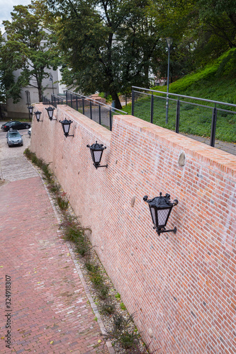 Brick wall with lanterns clote to Ostrogski Palace, or Ostrogski Castle (Pałac Ostrogskich, or Zamek Ostrogskich), Warsaw, Poland photo