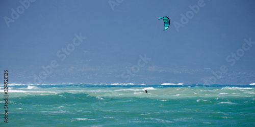 Panoramic view of the ocean with kite surfer on a windy day on Maui island in Hawaii.