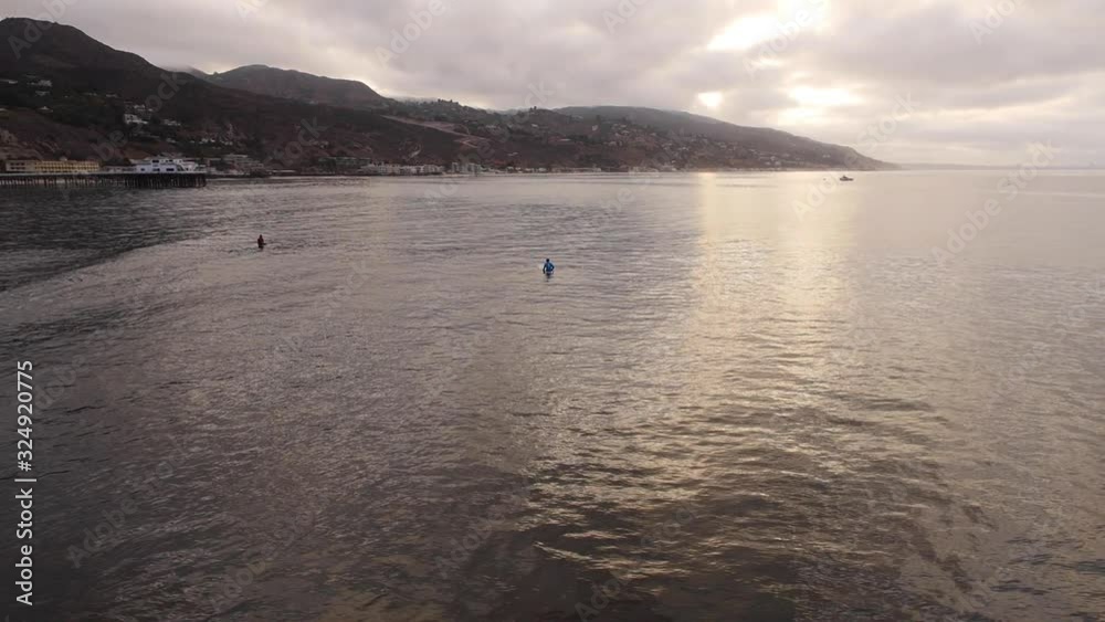 California surfers at sunset, wide aerial California surfers at sunset, wide aerial