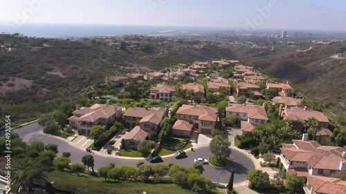 Panning aerial, suburban neighborhood in Newport Beach